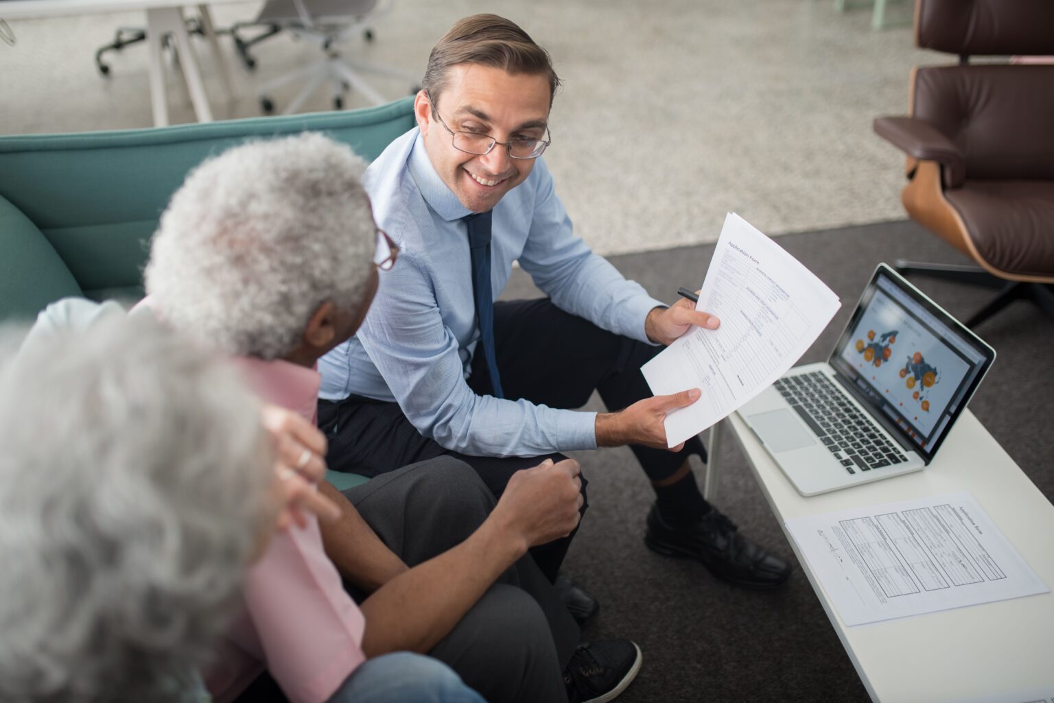 Financial advisor reviewing a retirement plan with a couple at Alliance Advisors Wealth Management